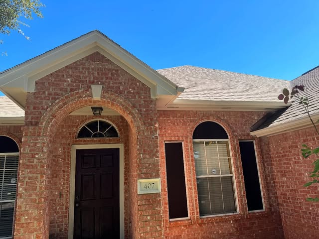 Arched brick front entry with repainted front door, fascia and gable trim