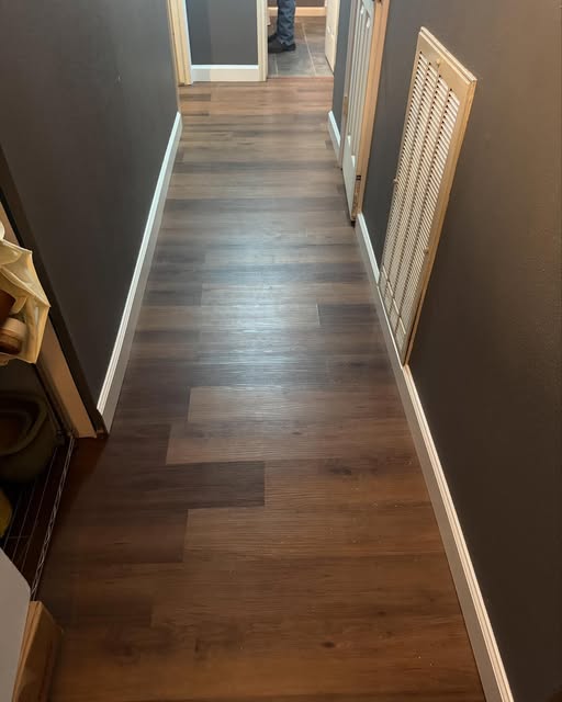 Hallway with new vinyl plank flooring and fresh baseboards