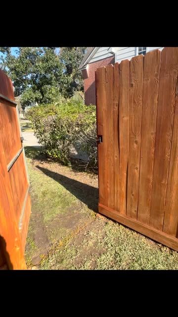 Stained wood fence gate rehung and latching cleanly
