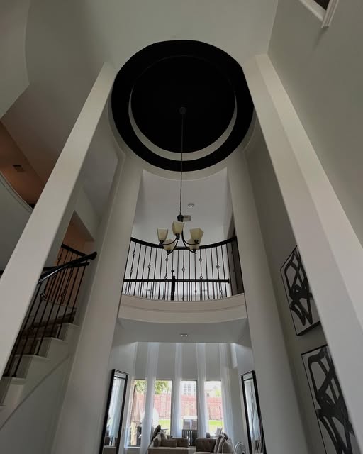 Two-story rotunda foyer with repainted walls and a black-accented ceiling dome